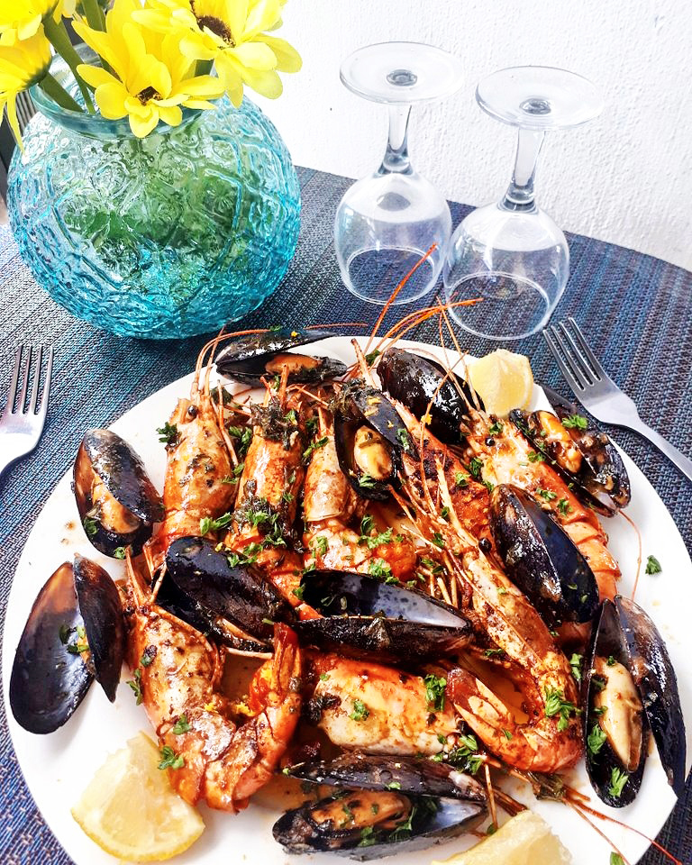 Holiday season: Mussels and grilled king Prawns in butter lemon and herbs sauce